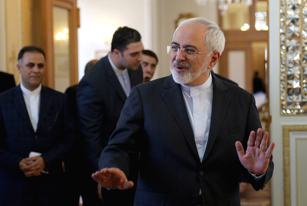 Iranian Foreign Minister Mohammad Javad Zarif gestures as he arrives for a meeting with his Japanese counterpart, Fumio Kishida, on October 12, 2015 in the capital Tehran. Kishida said on his visit to Tehran he hoped Iran’s nuclear deal with world powers would be swiftly implemented because his country wants to benefit from it. AFP PHOTO / ATTA KENARE